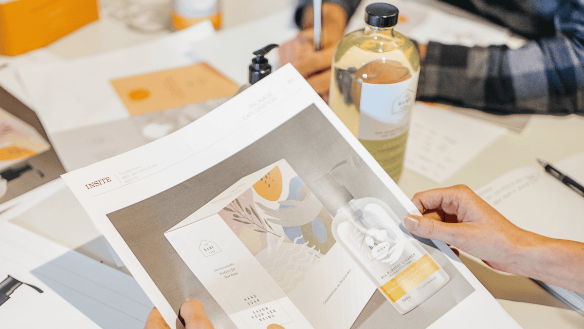 "The Bare Home founder reviewing label design with the team — the behind-the-scenes work of evolving a product thoughtfully."