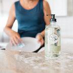 Women washing plate with natural dish soap