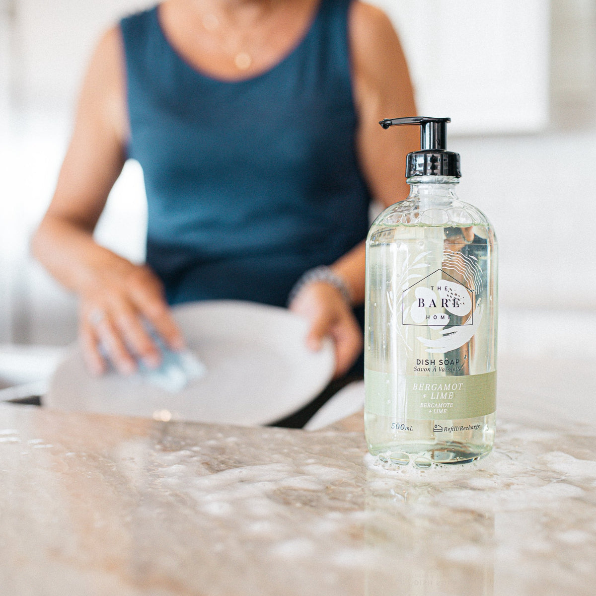 Women washing plate with natural dish soap